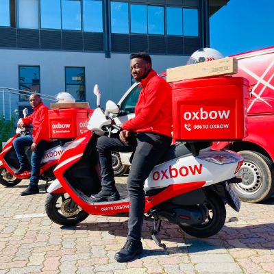 Oxbow branded red delivery scooter outside the Oxbow offices