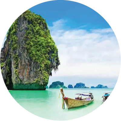 Tropical limestone island with a longtail boat on the sea