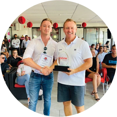Two Oxbow colleagues smiling at a recognition event