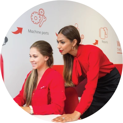 Two Oxbow staff members in red working together during training